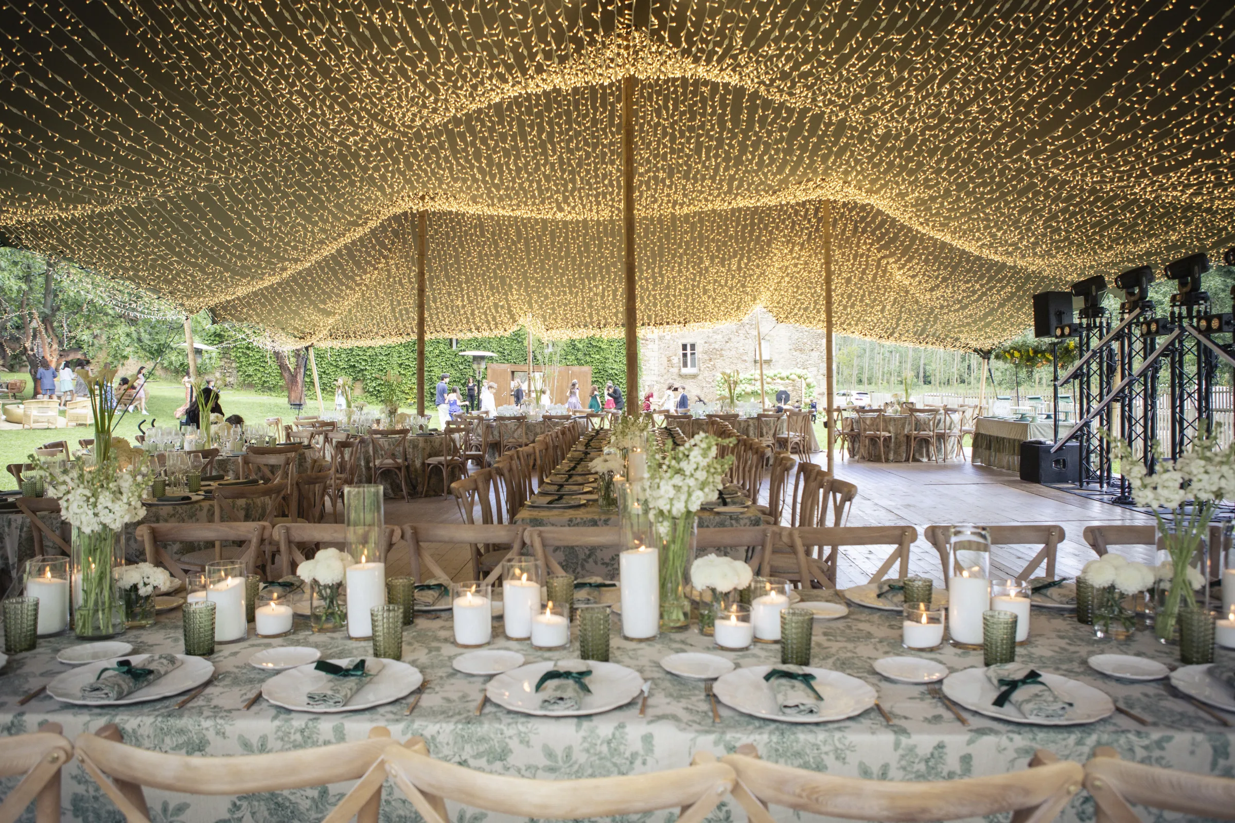 Fairy-light canopy glowing above gala dinner tables