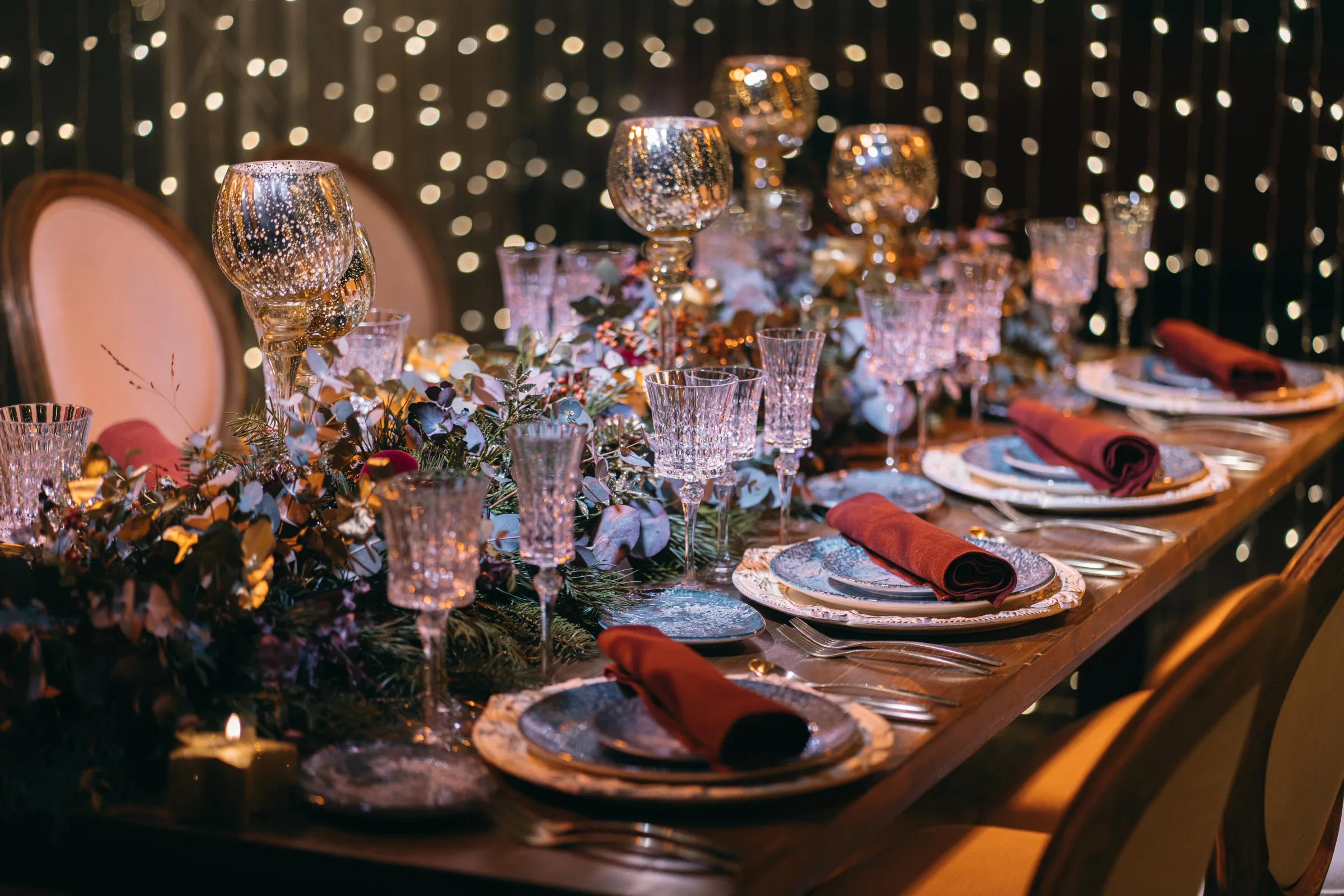 Gatsby ballroom with a gold sequin backdrop, white feather centerpieces and banquet tables