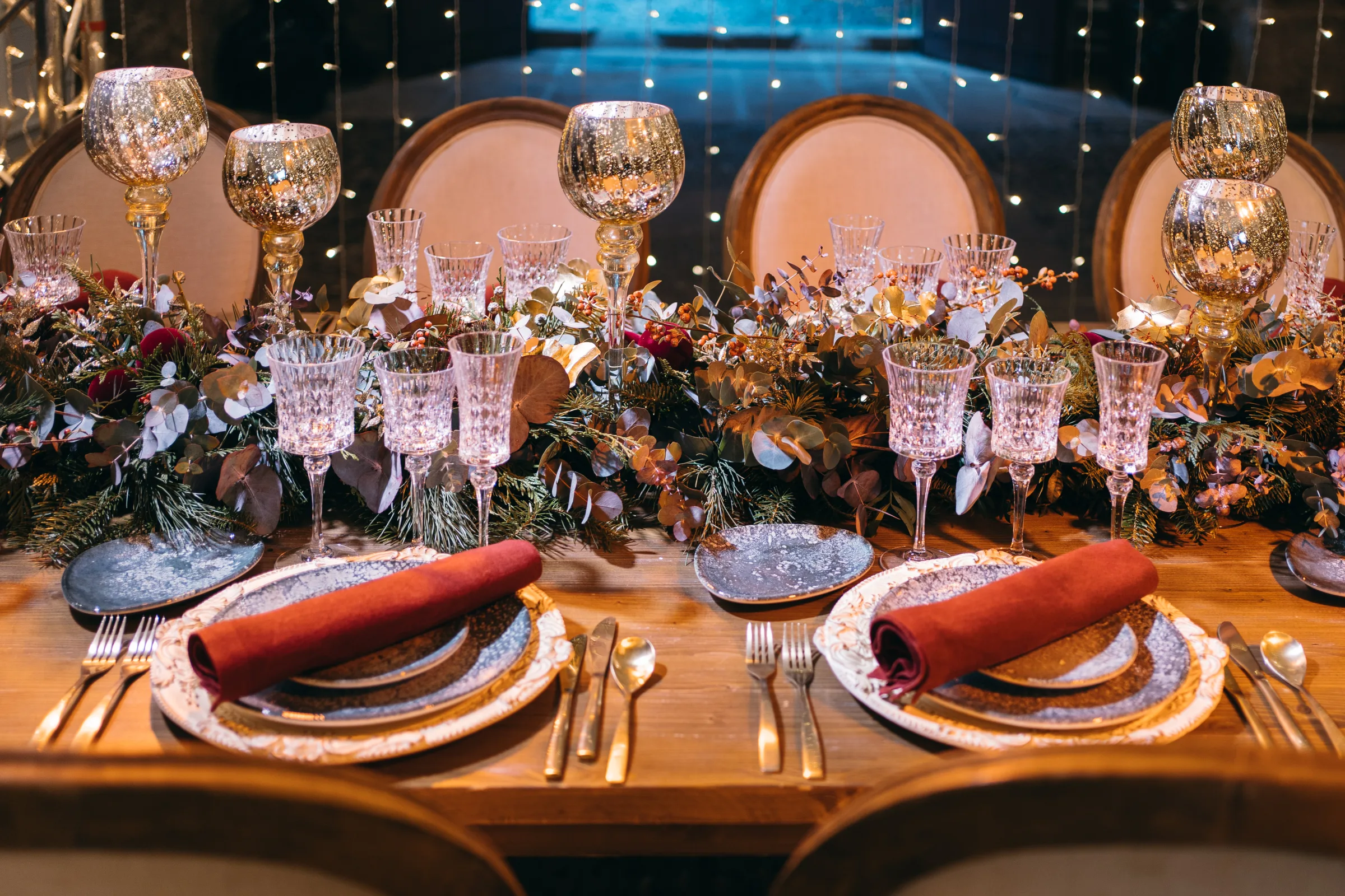 Ceremony room with gilded chiavari chairs, navy velvet and white orchids